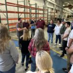 Leadership program members touring a manufacturing facility.